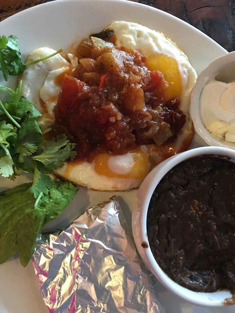 plate of breakfast food  black beans and tortillas