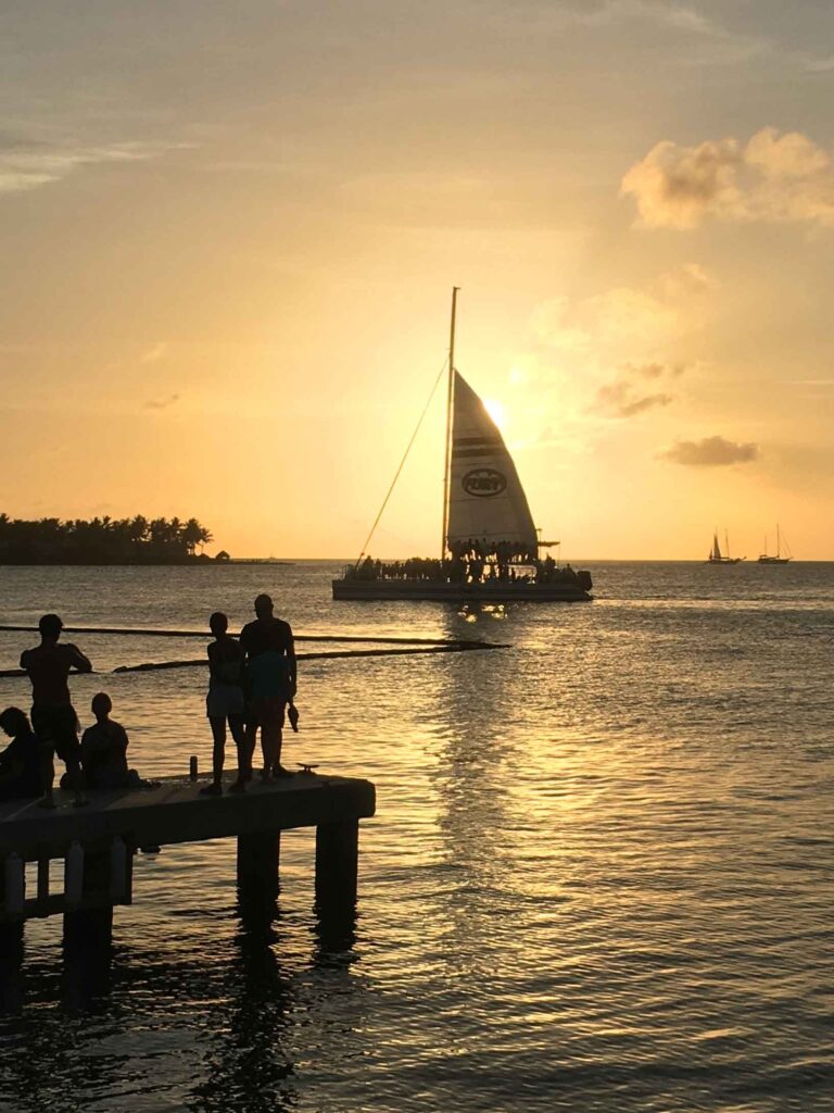 key west in august sailboat on water at sunset