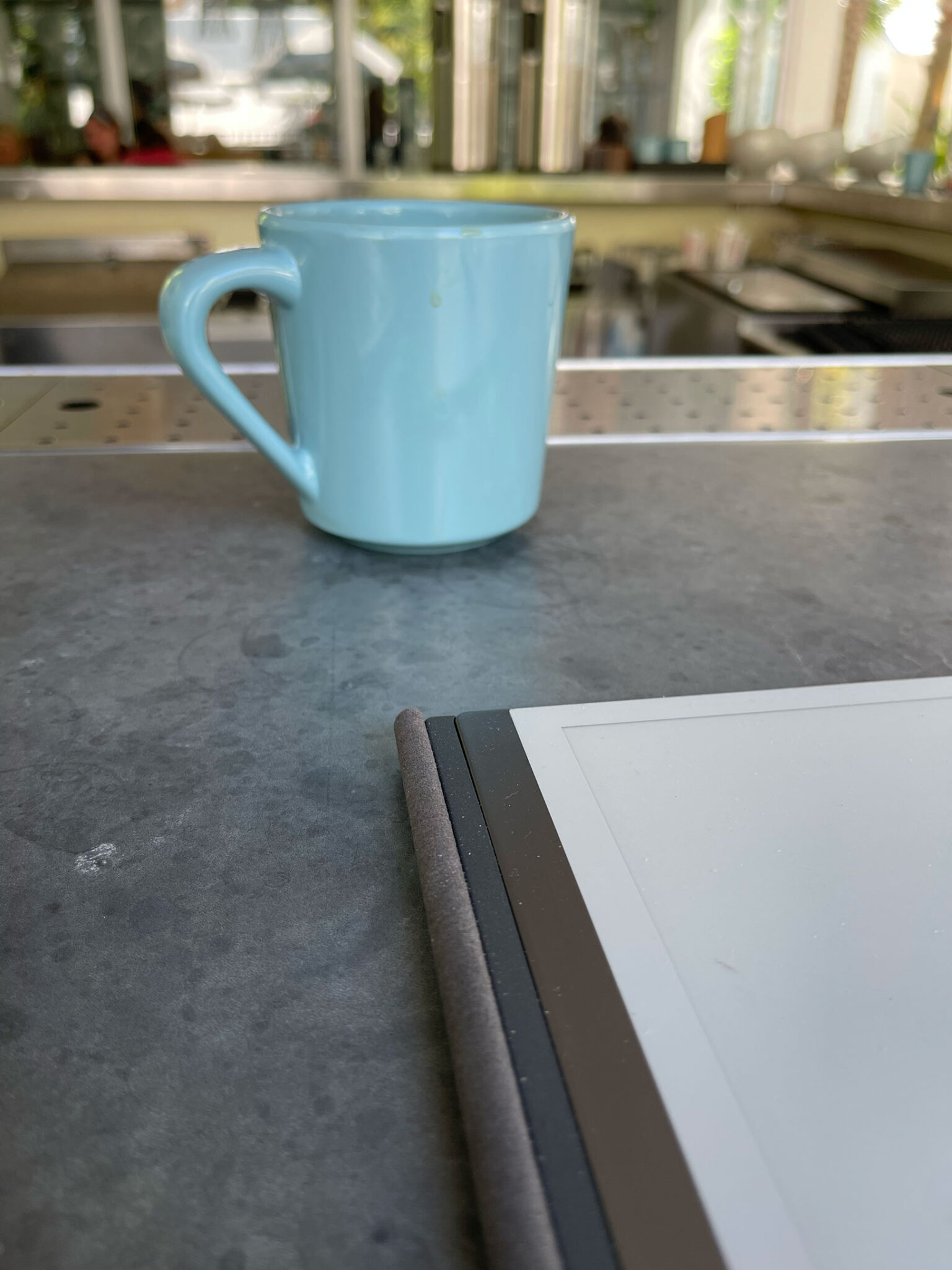 lap top and coffee cup on bar top