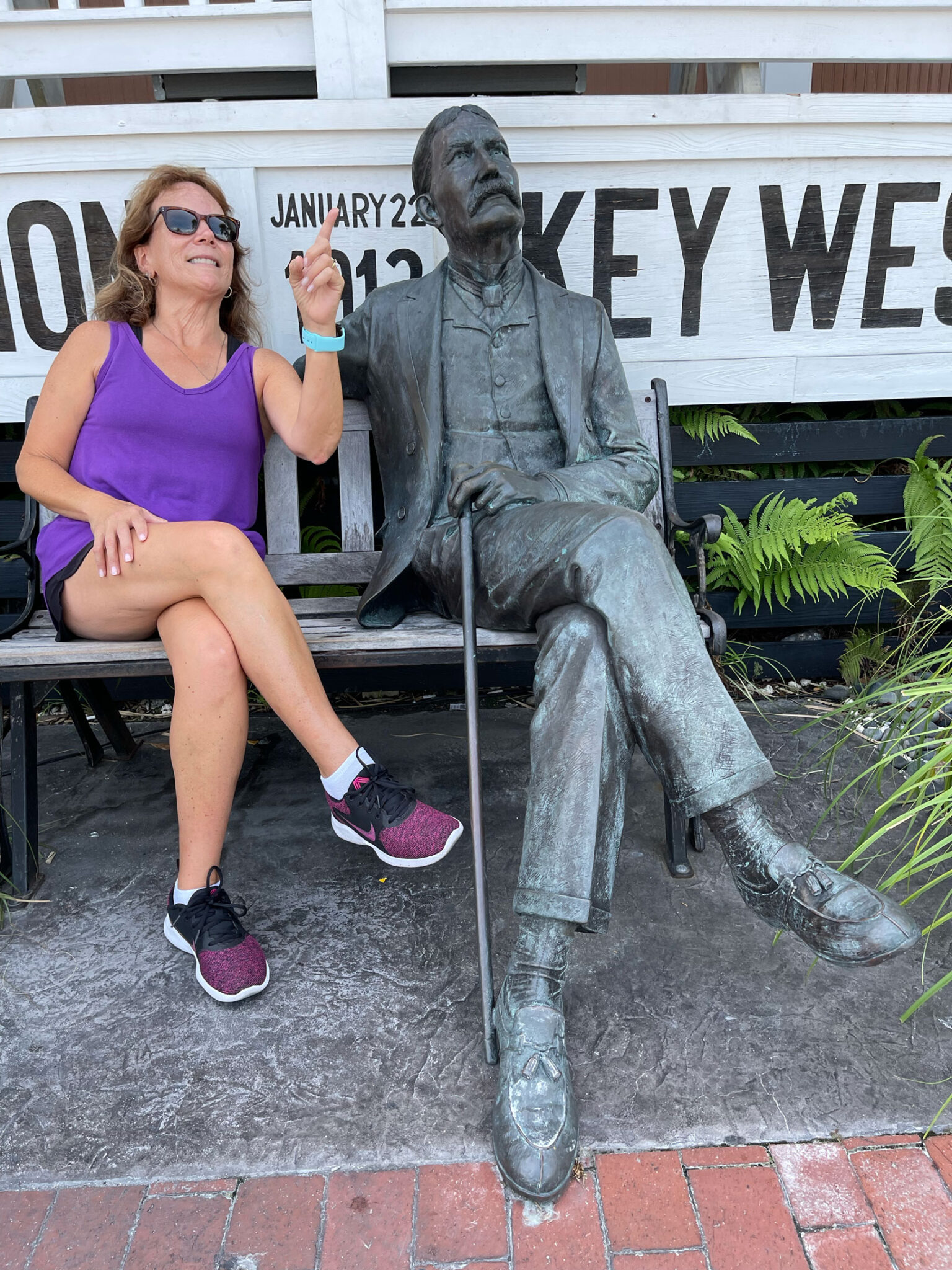 michele stitting with flagler statue in key west