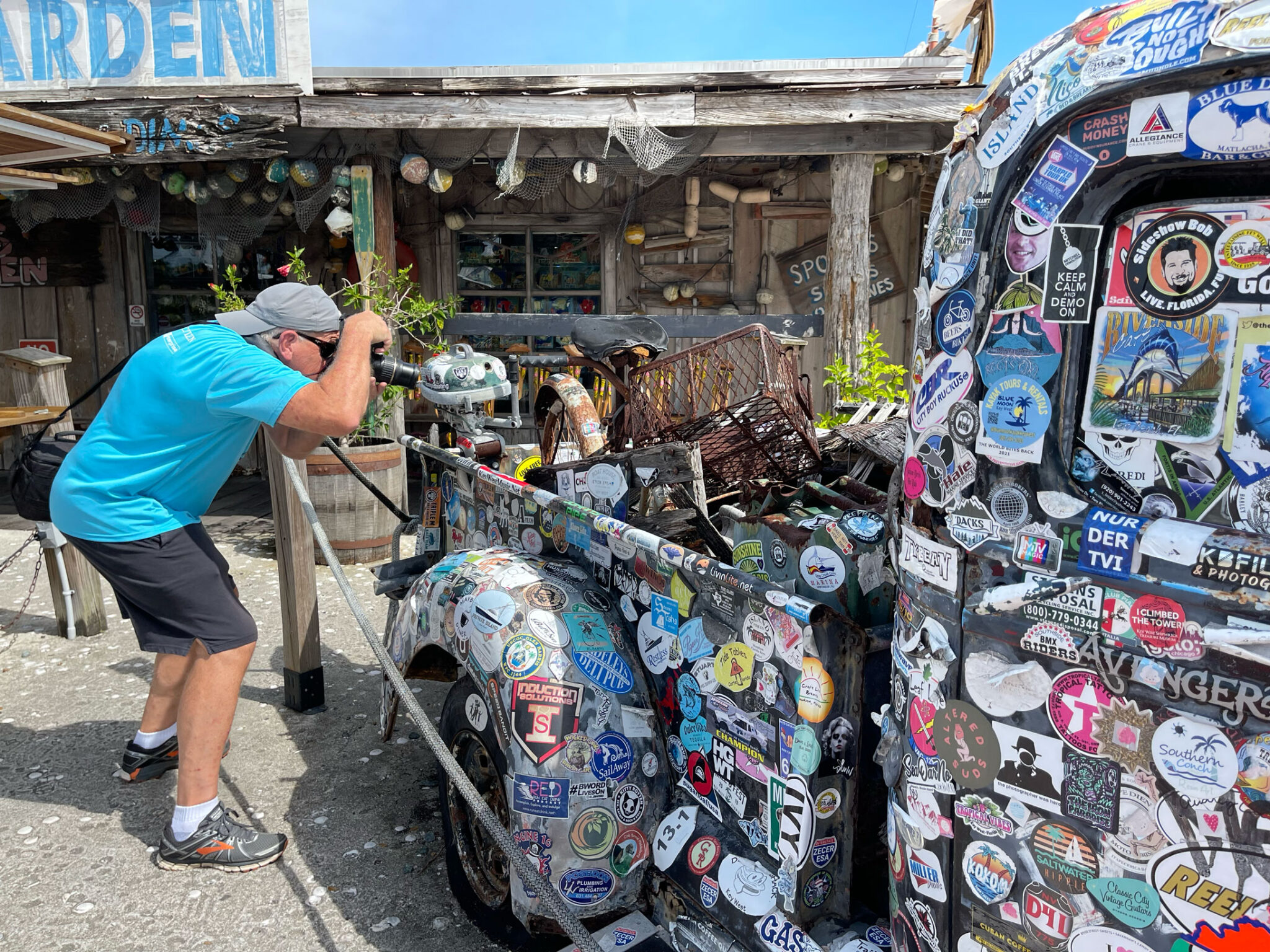 kevin taking pictures of sticker covered car in key west