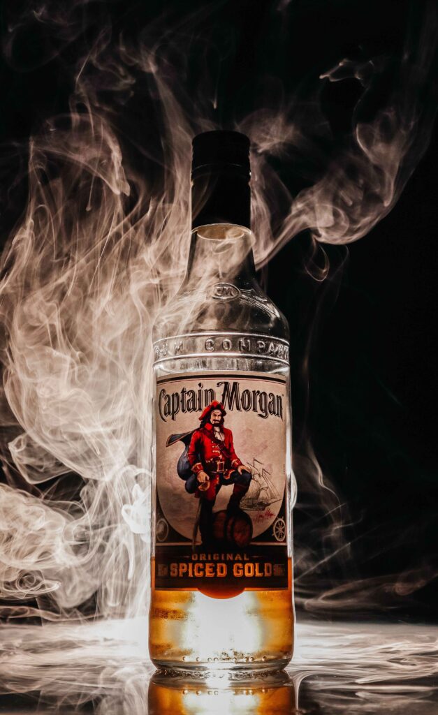 bottle of captain morgan rum with smoke in the back